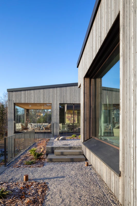 Grey exterior cladding in varying widths on a detached house