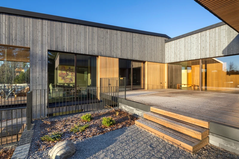 Grey exterior cladding in varying widths on a detached house