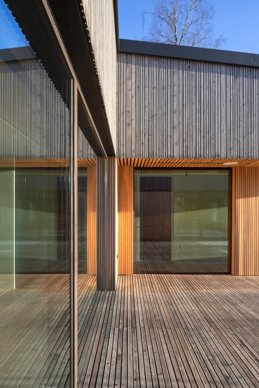 Grey exterior cladding in varying widths on a detached house