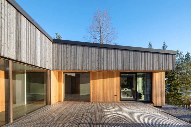 Grey exterior cladding in varying widths on a detached house