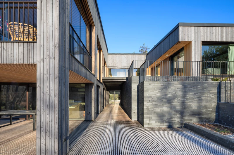 Grey exterior cladding in varying widths on a detached house