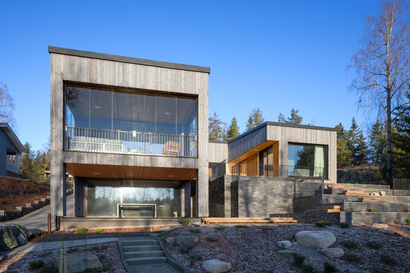 Grey exterior cladding in varying widths on a detached house